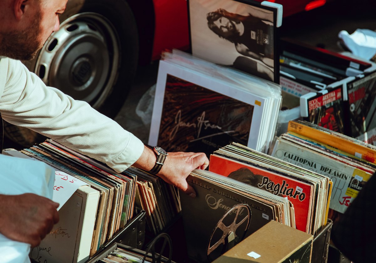 Man holding vinyl records at street market