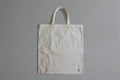 White canvas tote bag on gray background