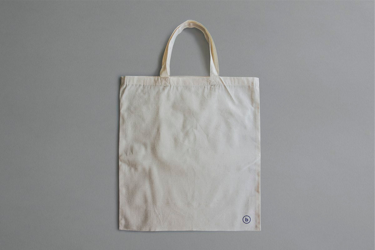 White canvas tote bag on gray background