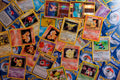 Colorful trading cards scattered on flat surface