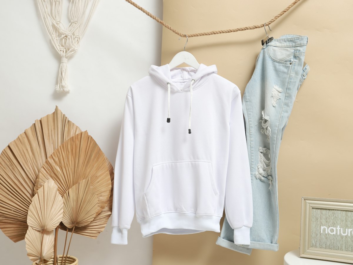 White hoodie and blue jeans hanging