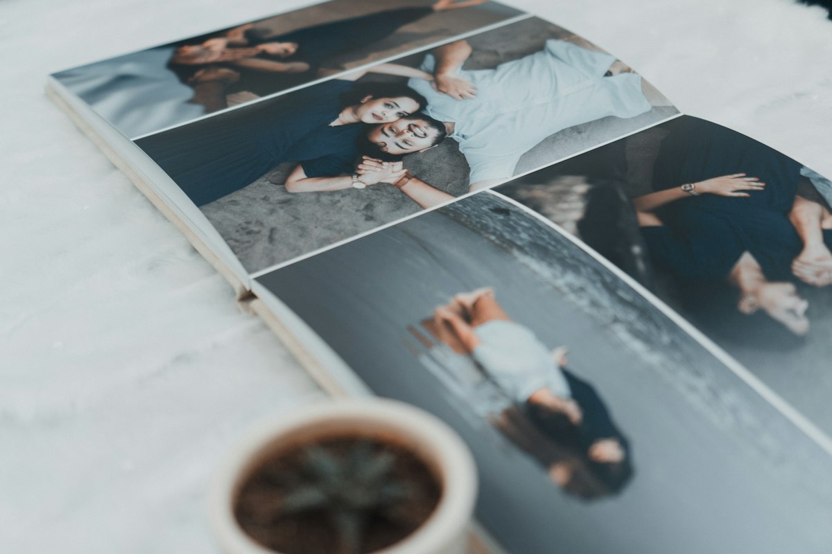 Open photo book showing four grayscale portraits