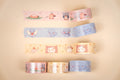 Four decorative washi tape rolls with cat designs