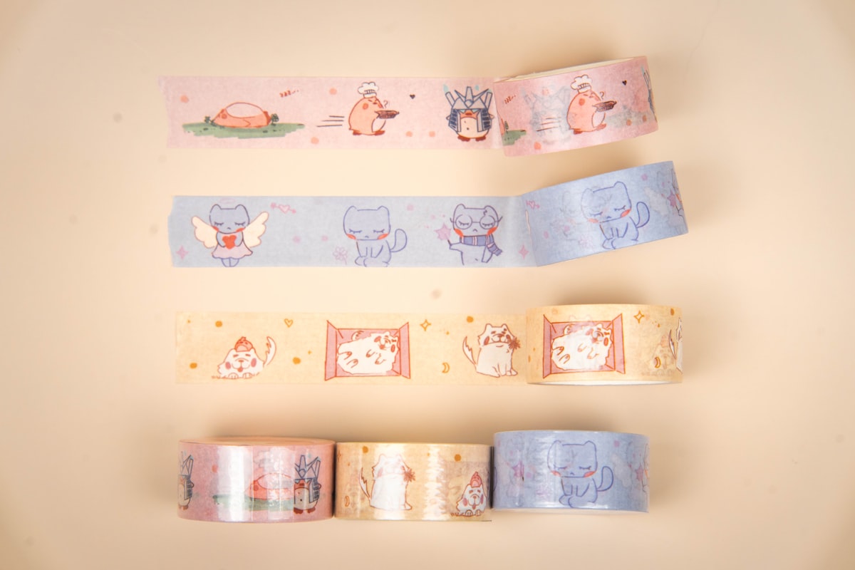 Four decorative washi tape rolls with cat designs
